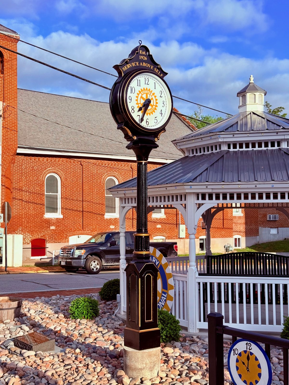 The dedicated Rotary street clock, Est. 1926 Service Above Self, beside the gazebo
