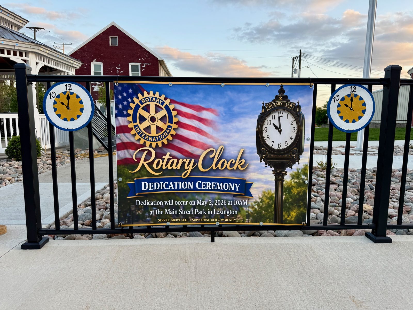 Rotary Clock Dedication Ceremony banner at Main Street Park, May 2, 2026
