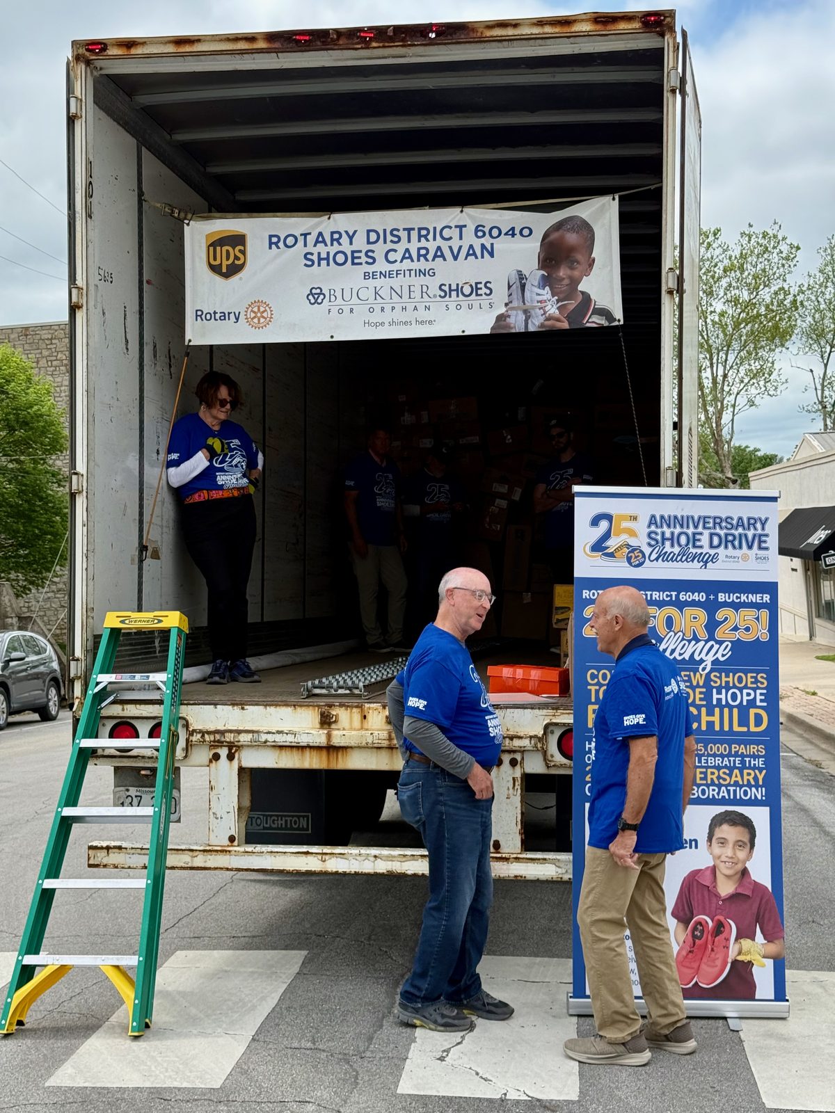 Incoming Rotary International President Larry Lunsford talking with Lexington Sergeant-at-Arms David Rich at the shoe truck