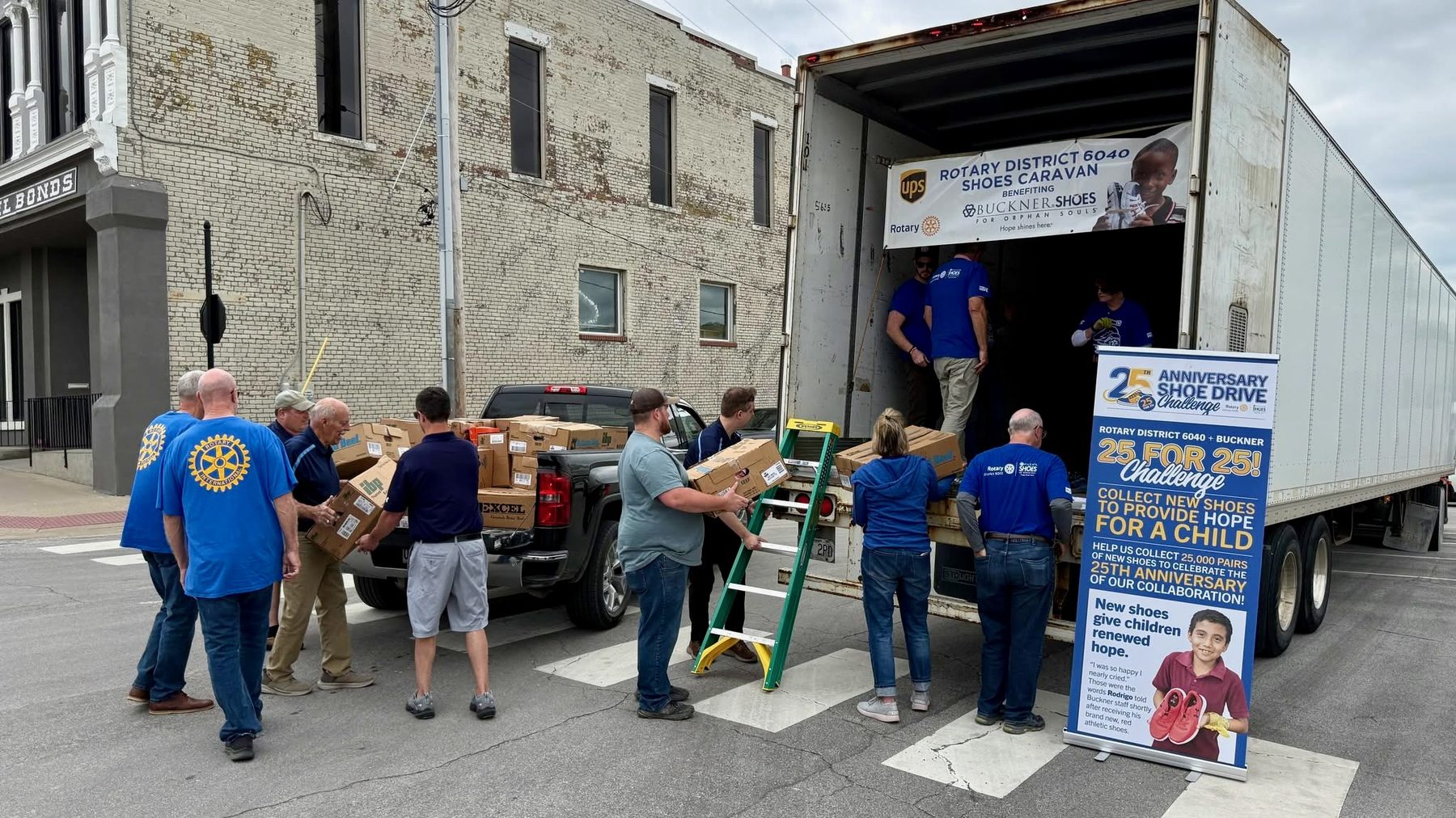 Lexington Rotarians loading boxes onto the Rotary District 6040 Shoes Caravan semi for Buckner Shoes for Orphan Souls